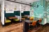 The interior of Abberly Foundry featuring green and white walls and a black table with orange accents at Abberly Foundry Apartment Homes in Nashville, TN