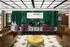 A view of the Abberly Foundry reception desk featuring purple and green chairs and a yellow accent at Abberly Foundry Apartment Homes in Nashville, TN