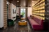 A cozy seating area featuring a purple couch and a wooden coffee table in front of a stylish wall at Abberly Foundry Apartment Homes in Nashville, TN
