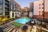 Outdoor pool area featuring lounge chairs and umbrellas at Abberly Foundry Apartments in Nashville, TN
