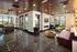 A stylish view of the lobby featuring a red couch and black and white tile floor at Abberly Foundry Apartment Homes in Nashville, TN