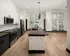 A kitchen with white and black two-tone cabinets, black countertops, and modern appliances at Abberly Riverwalk Apartments in Nashville, TN