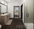 A bathroom with a glass shower stall and a large wall mirror at Abberly Riverwalk Apartments in Nashville, TN