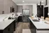 A kitchen with dark cabinets and white granite countertops at Abberly Riverwalk Apartments in Nashville, TN