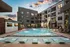 A resort-style pool with in-water seating, lounge chairs, and luxurious amenities at Abberly Riverwalk Apartments in Nashville, TN