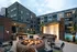 An outdoor patio with a fire pit, lounge chairs, and modern outdoor amenities at Abberly Riverwalk Apartments in Nashville, TN