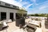 A rooftop patio with couches, chairs, and modern outdoor amenities at Abberly Riverwalk Apartments in Nashville, TN