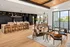 A demonstration kitchen with a large wooden table and modern cooking appliances at Abberly Riverwalk Apartments in Nashville, TN