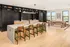 A demonstration kitchen with a large wooden table and modern cooking appliances at Abberly Riverwalk Apartments in Nashville, TN
