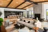 A large amenity center with a spacious couch, a cozy fireplace, and luxurious amenities at Abberly Riverwalk Apartments in Nashville, TN