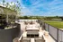 A rooftop patio with couches, chairs, and modern outdoor amenities at Abberly Riverwalk Apartments in Nashville, TN