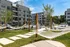A hammock in the courtyard of an apartment building with lush surroundings and modern amenities at Abberly Riverwalk Apartments in Nashville, TN