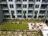 An aerial view of an apartment building featuring a lush lawn and a cozy fire pit at Abberly Riverwalk Apartments in Nashville, TN