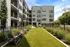 Relaxing grassy area with lounge chairs and a cozy fire pit in the heart of an apartment complex at Abberly Riverwalk Apartments in Nashville, TN