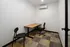 A small conference room featuring a table and two chairs at Abberly Riverwalk Apartments in Nashville, TN