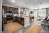Modern apartment showcasing an open-concept kitchen and living area, featuring sleek cabinetry, cozy seating, and abundant natural light.