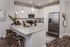 Modern kitchen with sleek granite countertops, stainless steel appliances, and stylish pendant lighting, perfect for entertaining.