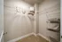Spacious walk-in closet with elegant shelving, neutral tones, and organized storage baskets.