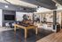 Chic and modern entertainment lounge featuring a sleek pool table, cozy seating area, stylish bar stools, and artistic decor for a vibrant ambiance.
