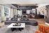Sophisticated open-plan living area featuring modern lounge furniture, stylish bar seating, and a chic pool table, with ample natural light streaming through large windows.