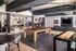 Chic and modern recreational lounge featuring a pool table, shuffleboard, stylish bar seating, and inviting lounge area with a large TV.