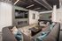 Modern living room with stylish gray sofas, elegant fireplace, and a mounted flat-screen TV, perfect for cozy gatherings.