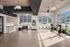 Bright and modern fitness room featuring large windows, exercise bikes, kettlebells, and sleek storage solutions.
