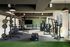 Modern fitness center with high-end gym equipment, inviting natural light, and spacious workout areas.