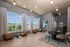 Elegant and spacious apartment lounge with stylish decor, natural light from large windows, and a modern dining set.