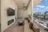 Modern outdoor terrace with sleek seating, mounted TV, and scenic city views, ideal for relaxation and entertaining.