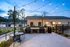 Charming outdoor patio with string lights, featuring cozy seating and dual grills, perfect for entertaining in the evening.