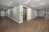 Modern apartment hallway with sleek wooden flooring and elevator access.