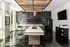 Chic industrial-style kitchen with sleek modern appliances, artistic wall mural, and inviting natural light.