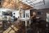Stylish and modern recreational space featuring a pool table, foosball, basketball arcade game, and lounging area with sleek industrial design and natural light.
