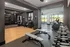 Modern fitness center with state-of-the-art gym equipment, sleek design, and large windows with scenic views.
