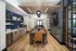 Contemporary dining area with sleek wooden flooring, elegant cabinetry, and a stylish ceiling design, perfect for modern entertaining.