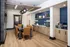 Modern dining area features sleek, leather chairs and a stylish table, complemented by contemporary lighting and a chic coffee station.
