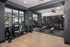 Modern fitness center with sleek gym equipment, mirrored walls, and ample natural light for an energizing workout environment.