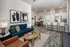 Contemporary open-plan living space with stylish furnishings, featuring a cozy blue sofa, modern kitchen island, and elegant dining area.