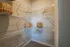 Spacious walk-in closet with white wire shelving, wooden hangers, and decorative woven baskets for stylish storage.