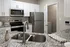 Modern kitchen showcasing sleek granite countertops, stainless steel appliances, and elegant cabinetry.