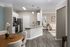 Chic open-plan kitchen and dining area with modern finishes and cozy bedroom view.