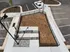 Sunny fenced concrete and mulch outdoor area, optimized for pet-friendly enjoyment, adjacent to vehicle parking.
