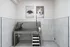 Modern pet washing station with stainless steel tub, step ladder, and charming dog portraits, offering convenience and style.