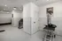 Modern pet grooming station in a sleek, tiled room featuring professional equipment and cheerful decor.