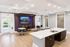 Modern communal dining area showcasing sleek countertops, elegant lighting, and comfortable seating with stylish decor.