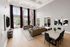 Elegant and modern living room with high ceilings, large windows, and stylish décor, offering a luxurious and welcoming ambiance.