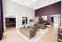 Luxurious open living area with high ceilings, elegant furniture, and modern decor in a bright and spacious setting.