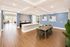 Modern open-concept dining area with elegant wooden flooring, contemporary decor, and abundant natural light.