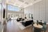Bright and spacious living area with high ceilings, modern furniture, and expansive windows inviting abundant natural light.